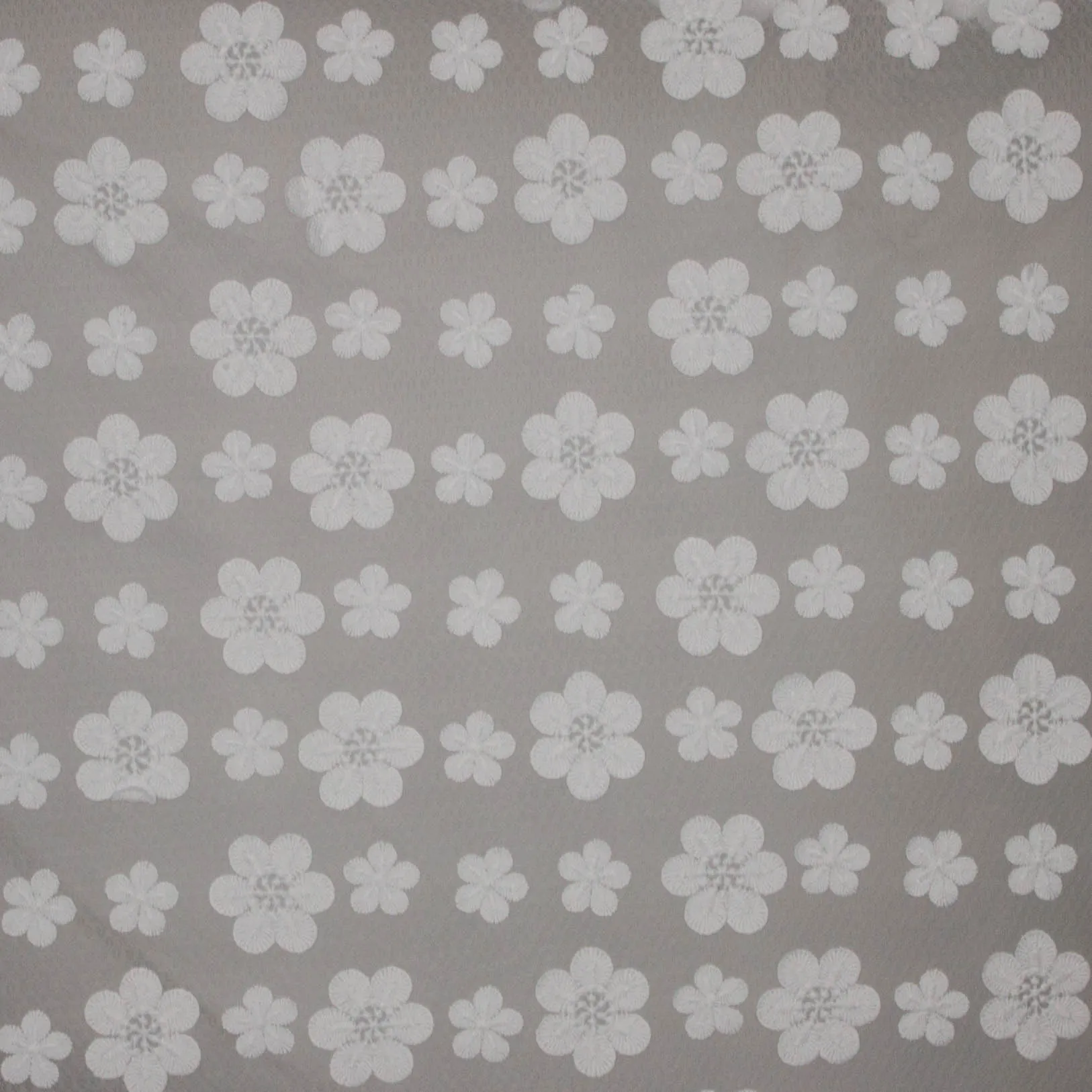Kant met geborduurde witte bloemen.