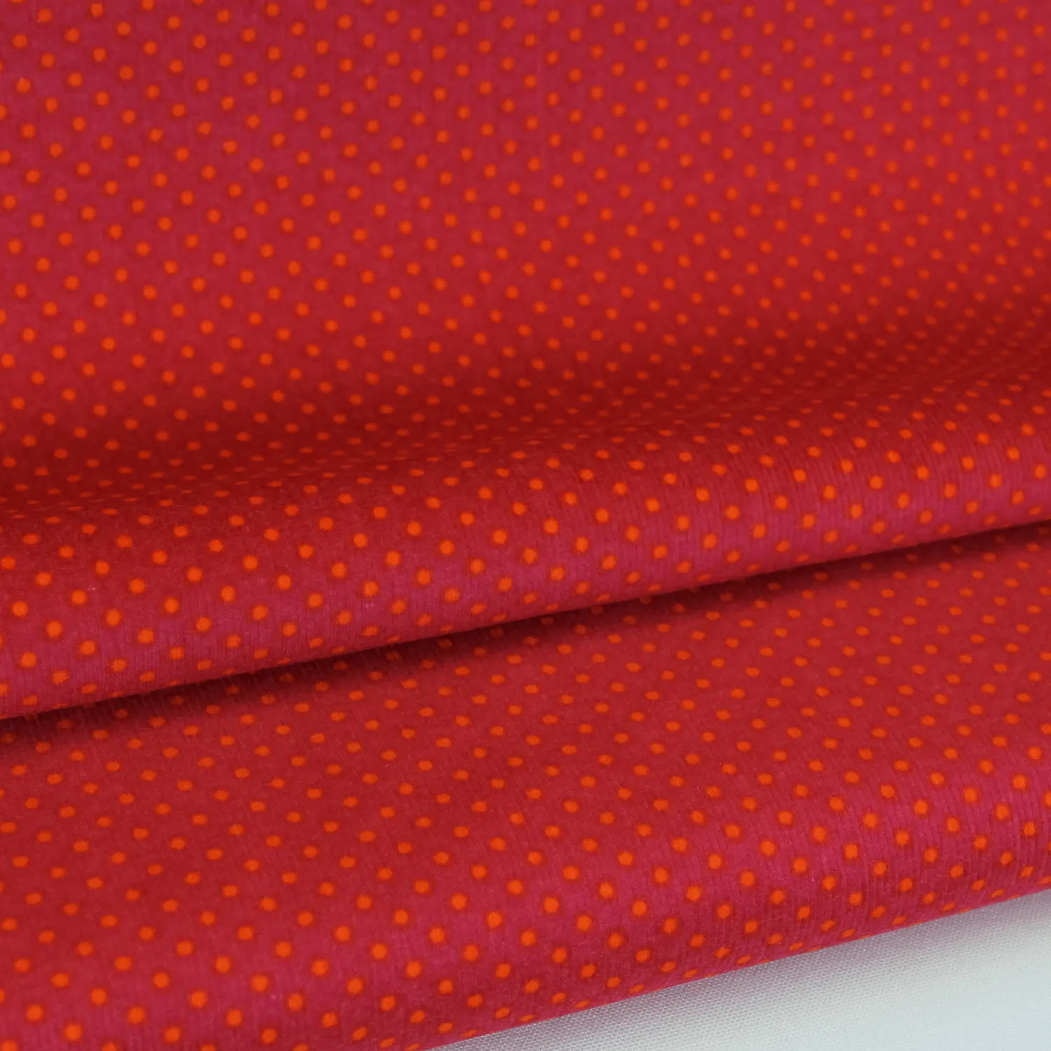 Ribfluweel roze met oranje stippen