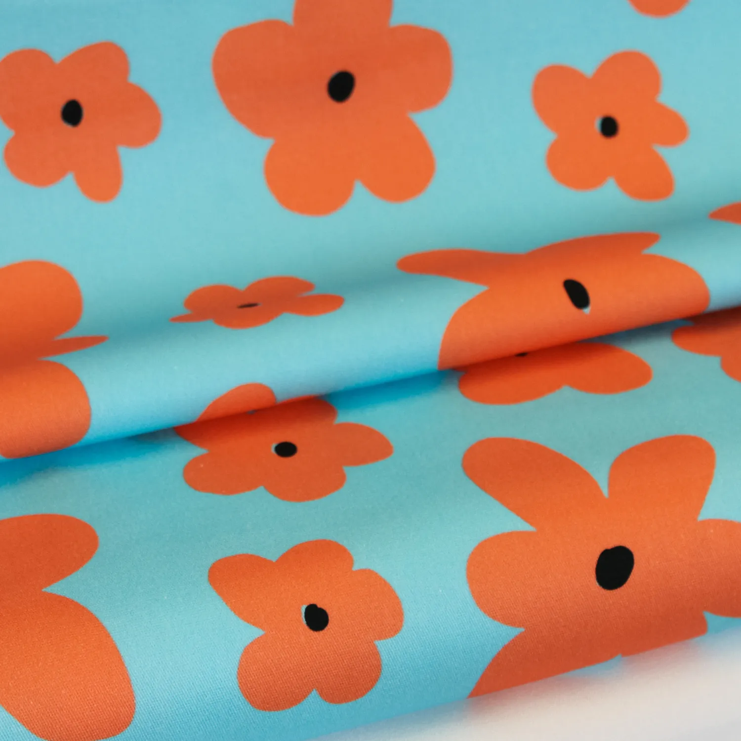 Katoen stretch blauw met oranje bloemen