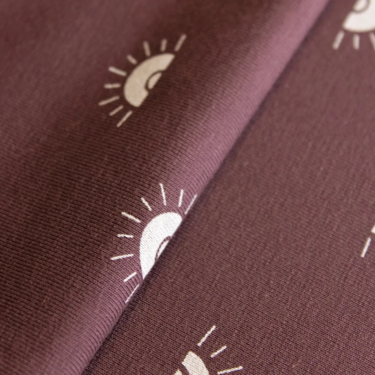 Katoen tricot mauve met zonnetjes