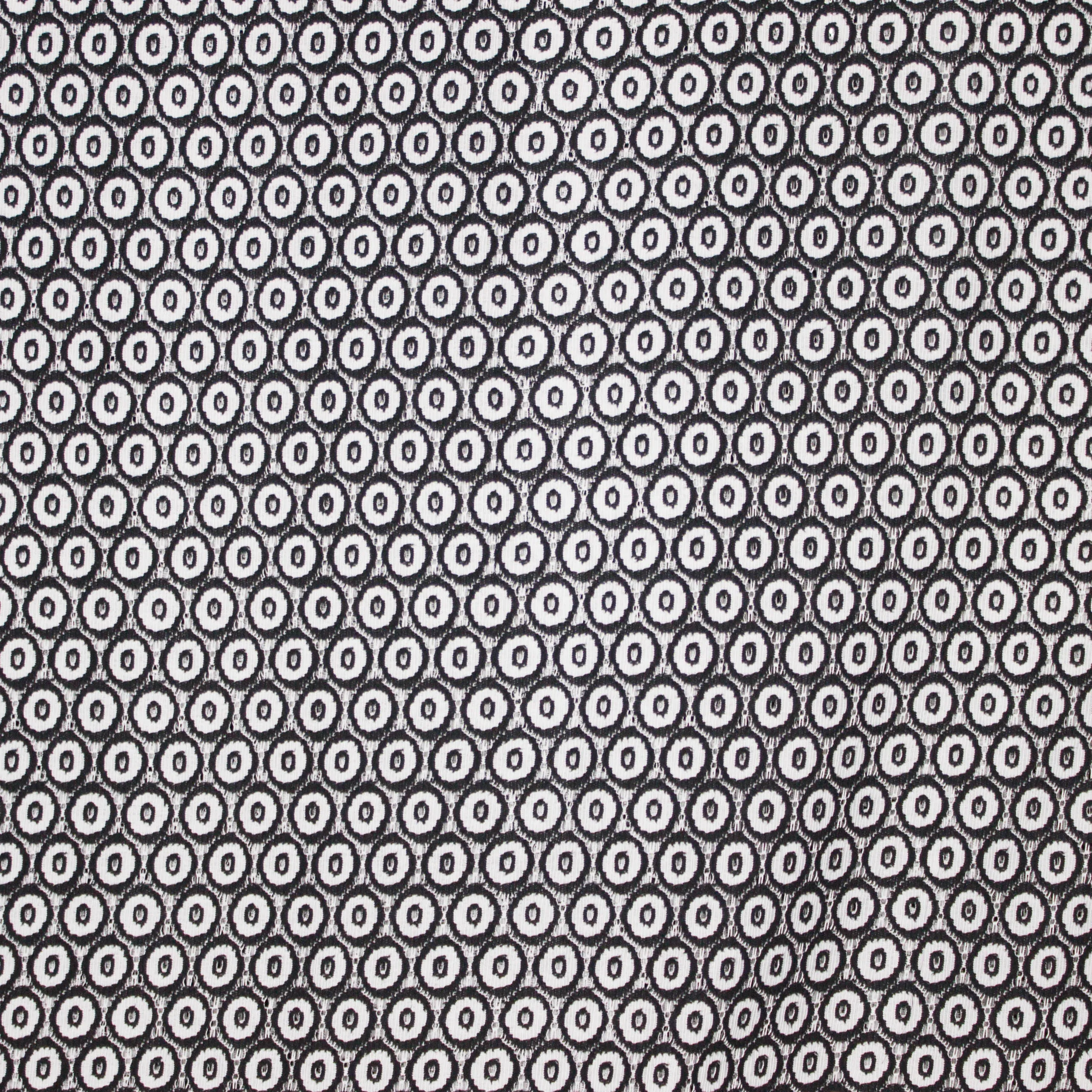 Polyester / nylon mengeling  met zwart en grijs bollen motief in kant look