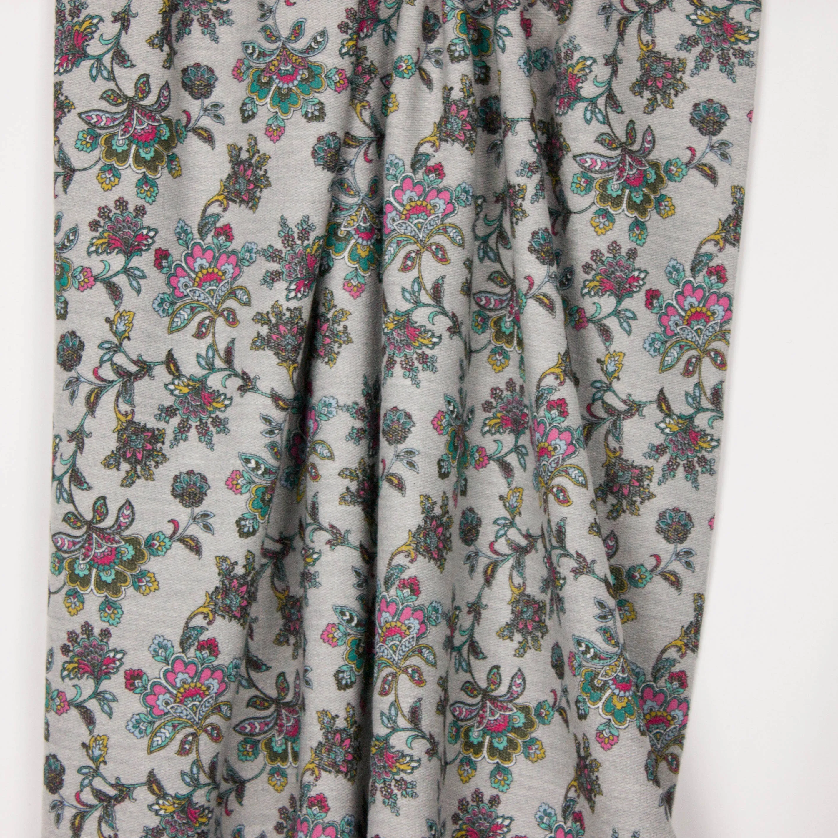 Grijze french terry met retro bloemenmotief op de lusjeszijde
